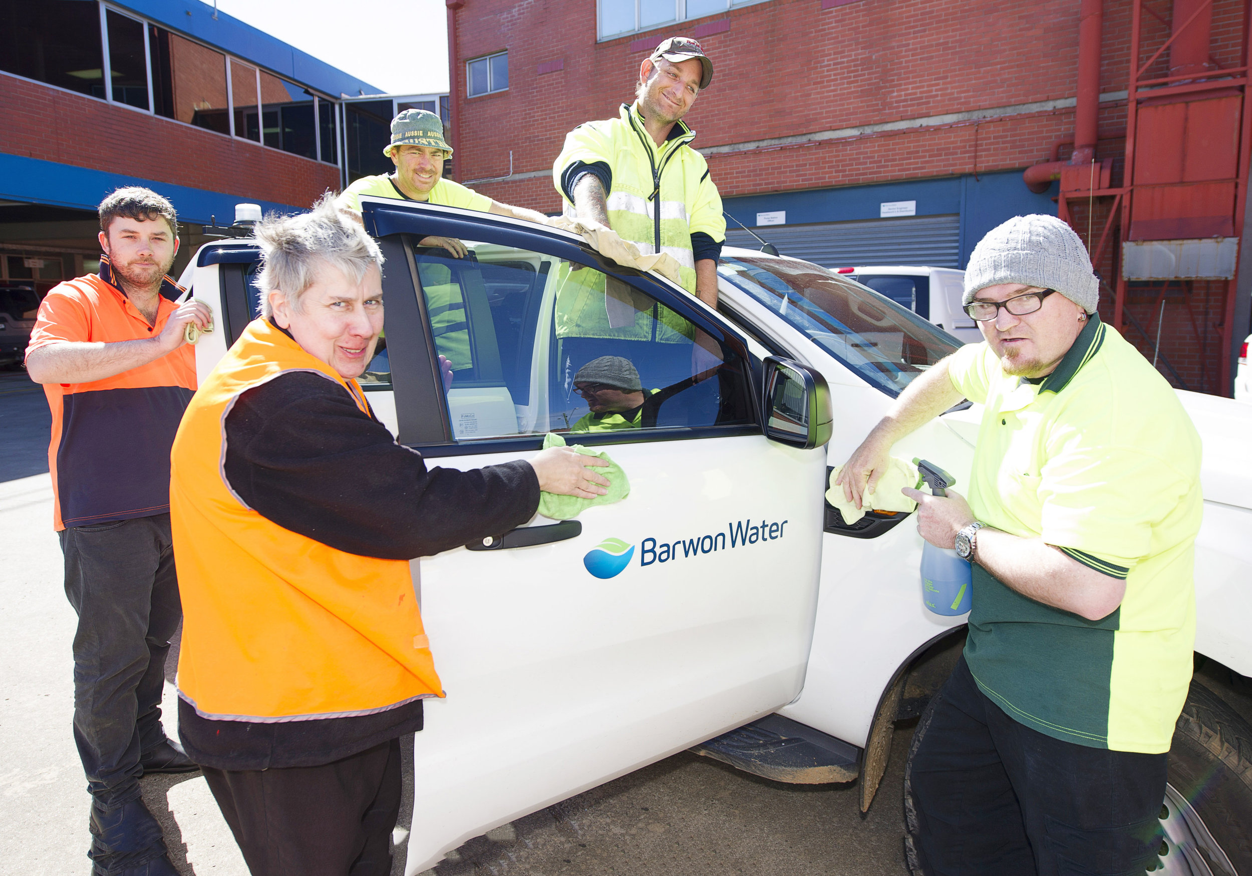 Trainees from genU cleaning Barwon Water vehicles, recruited as part of the GROW project.